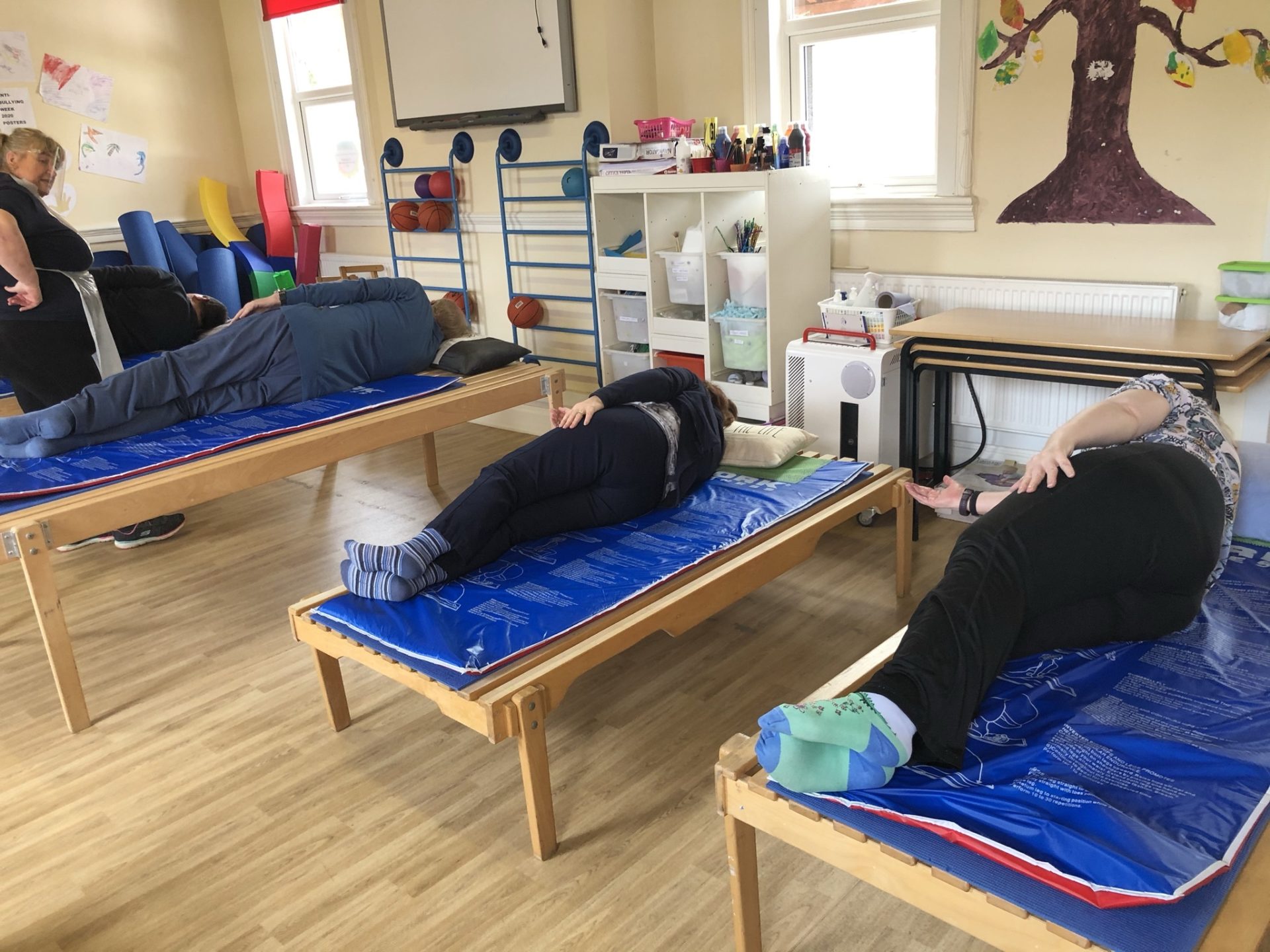 Parkinson's participants practice lying exercises at Megan Baker House